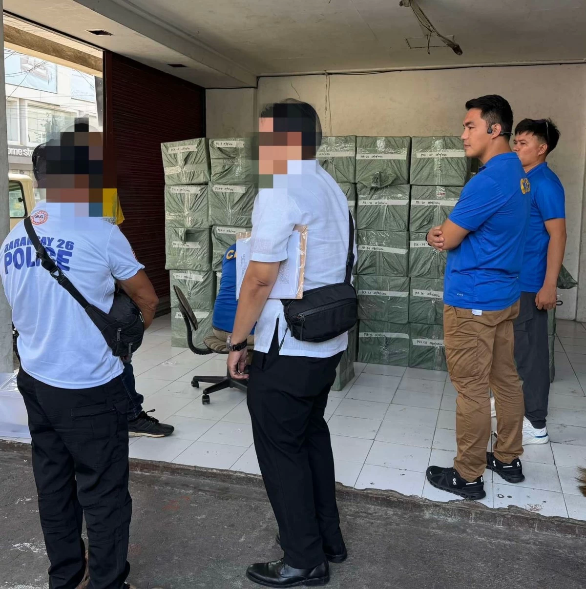 Authorities check on the 125 sacks of counterfeit seasoning worth P1.2 million surrendered by a courier firm to the authorities in Barangay 26, Bacolod City on Friday, August 14. (CIDG-Bacolod)