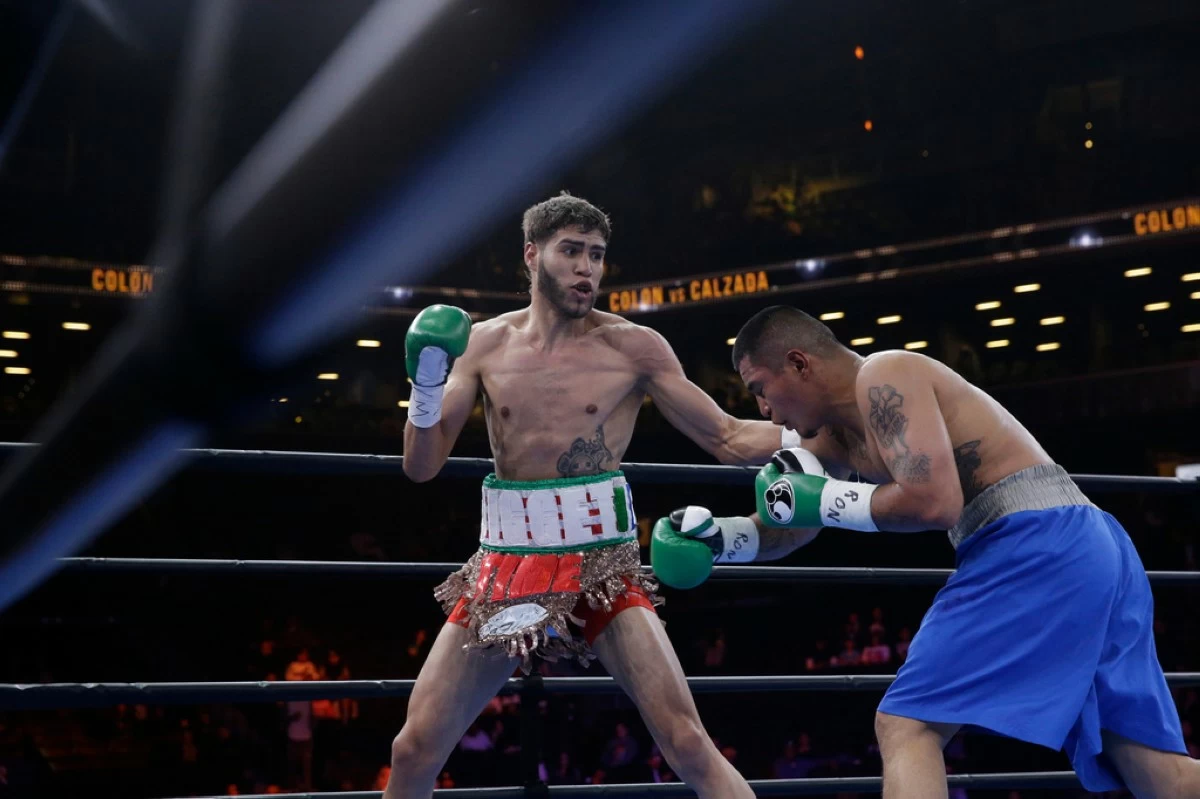 FILE - Prichard Colon, left, exchanges punches with Daniel Calzada during a junior middleweight title boxing match, Saturday, April 11, 2015, at New York. Colon won by TKO. (AP Photo/Mary Altaffer, file)