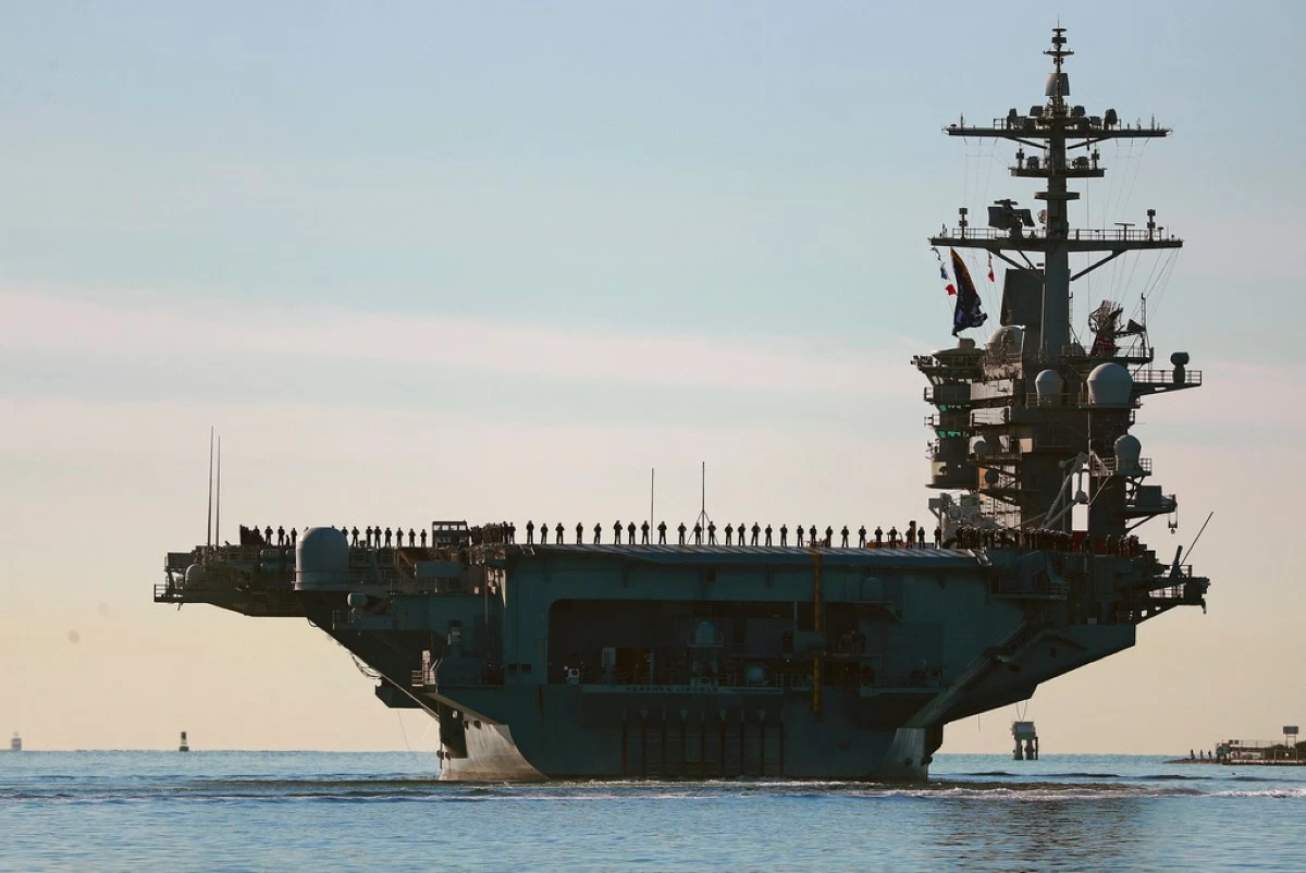 Sailors and Marines line the deck of aircraft carrier USS Abraham Lincoln (CVN-72) as it deploys from San Diego, Jan. 3, 2021. (K.C. Alfred/The San Diego Union-Tribune via AP, File)