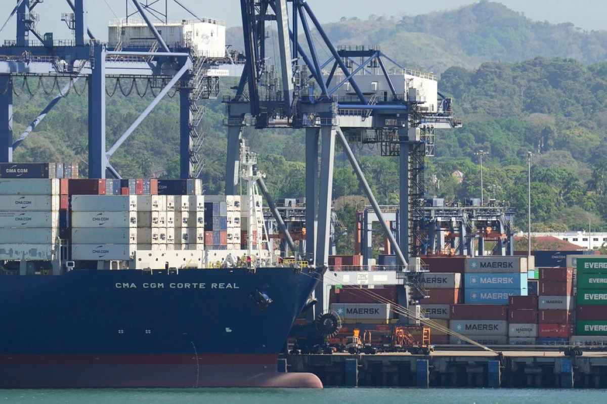 Cranes load a cargo ship at Panama Canal's Port of Balboa, managed by CK Hutchison Holdings, in Panama City, on Jan. 30, 2026. (AP Photo/Matias Delacroix, File)