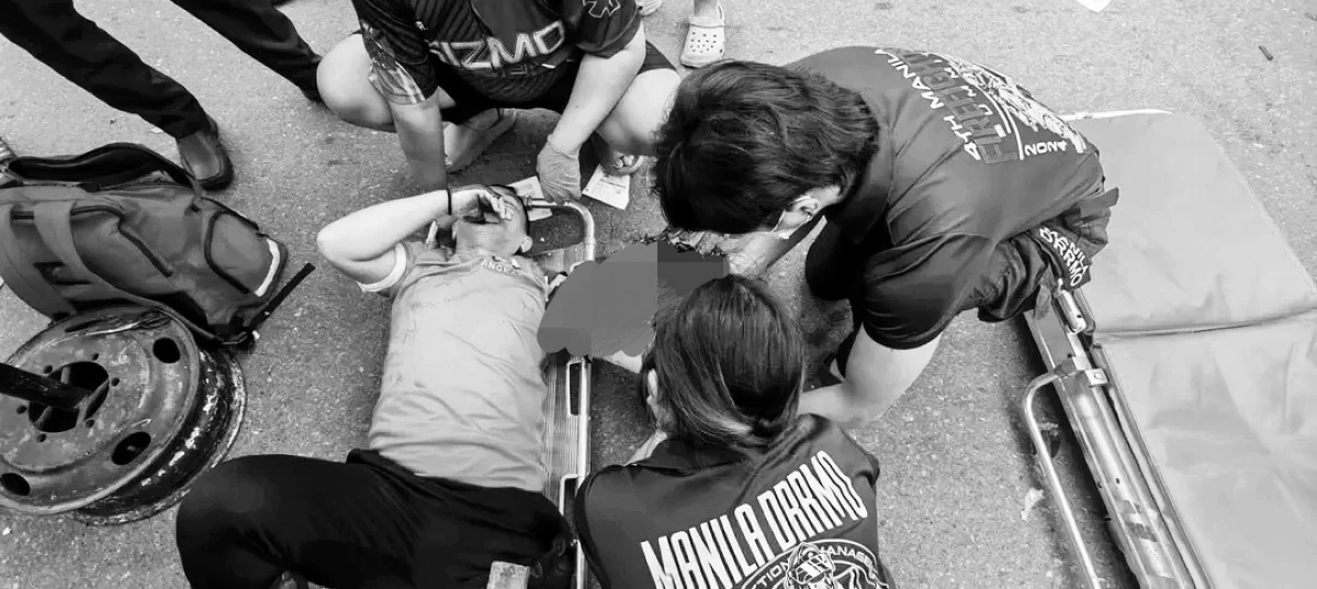Responders assist a 37-year-old motorcycle rider injured in a road crash along R10 in Manila on Wednesday, Aug. 19. (Photos from Manila DRRMO)