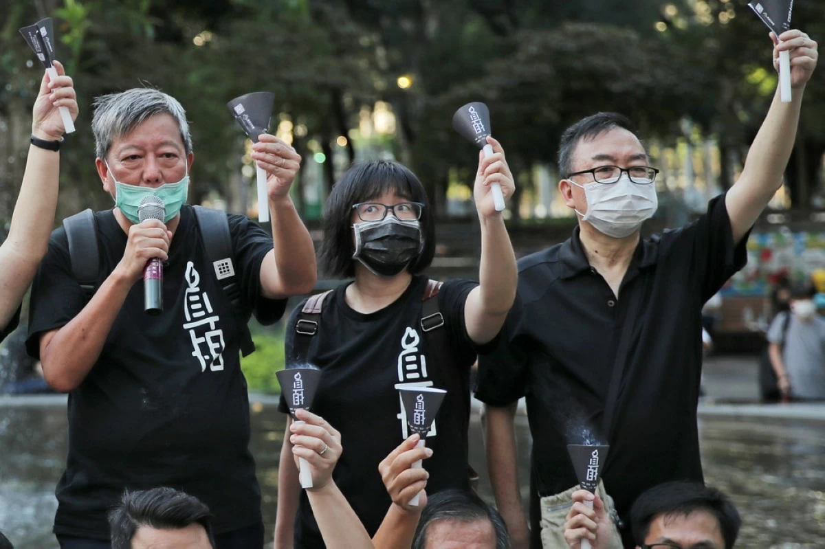 Fom left, pro-democracy activists Lee Cheuk-yan, Chow Hang-tung, and Cheung Man-kwong attend a gathering to mourn for those killed in the 1989 Tiananmen crackdown at Victoria Park, in Hong Kong on June 4, 2020. (AP Photo/Kin Cheung, File)