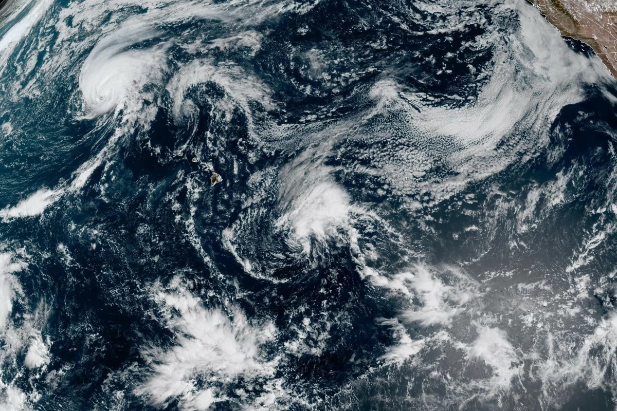 This satellite image released by NOAA shows Hurricane Lala, upper left, over the Pacific Ocean, northwest of Hawaii, Friday, Aug. 21, 2026. (NOAA via AP)