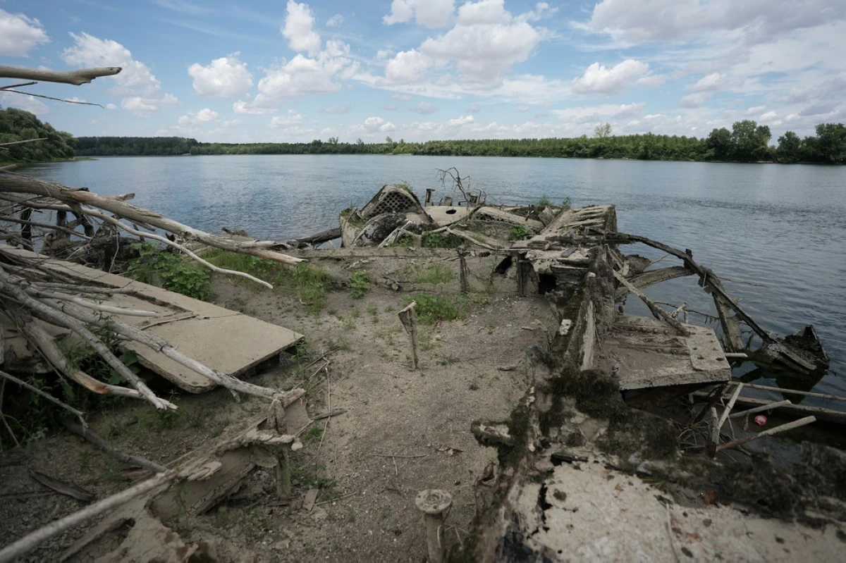 The wreckage of an old steam boat, known as the Slovenian, is visible due to the low level of the Sava river near the town of Sremska Mitrovica, northwest of the capital Belgrade, Serbia, Tuesday, Aug. 18, 2026. (AP Photo/Darko Vojinovic)