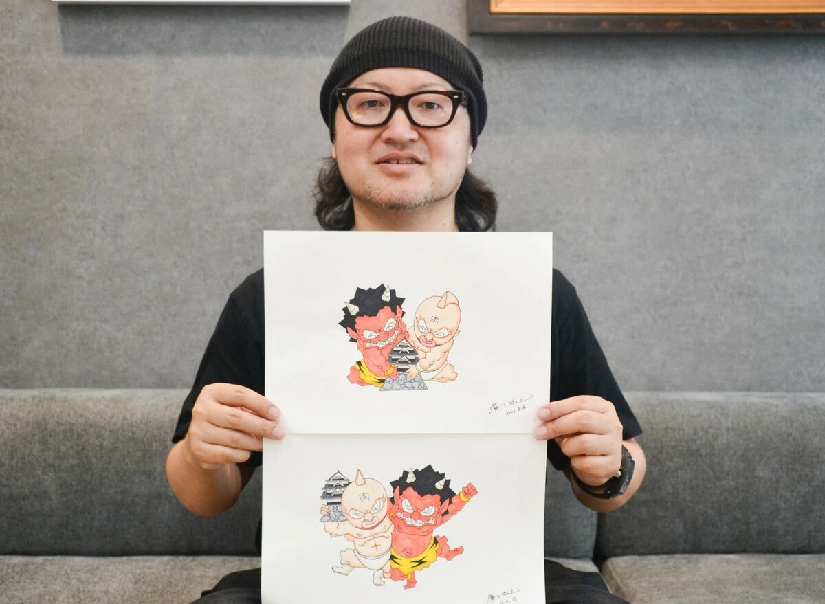 Kazuyuki Takishita holding collaborative works with the manga 
