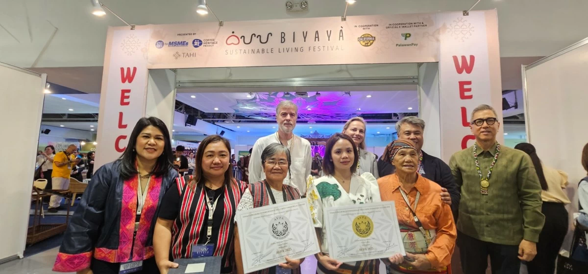 Lilian Castro-Selda, vice chairman and CFO of Palawan Group of Companies; Rich Watanabe, founder of Coffee Heritage Project and BIYAYA Festival (second from right), stand with local coffee farmers recognized by the AVPA and other guests.