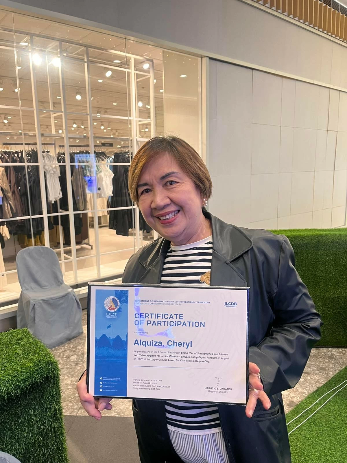 Cheryl Alquiza proudly shows her certificate after completing the AI learning session led by DICT-CAR at SM City Baguio