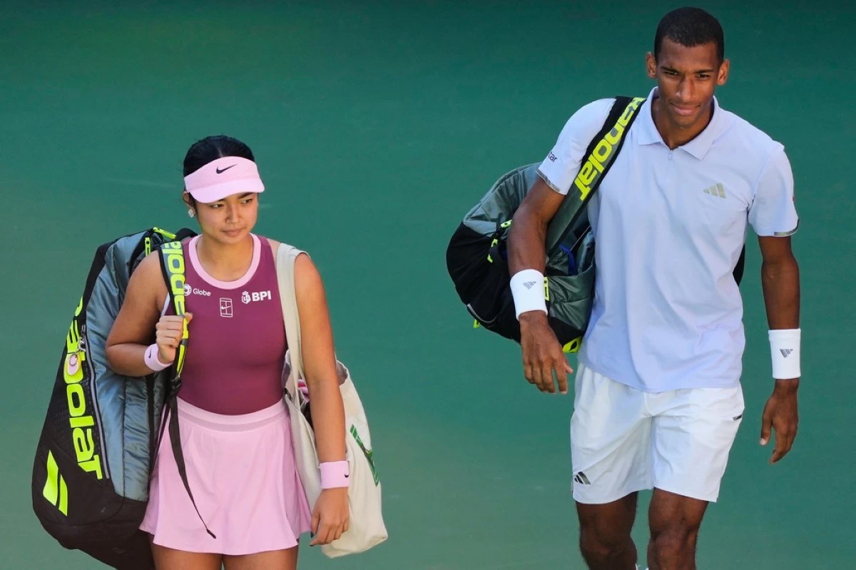 Alexandra Eala, of the Philippines, and Felix Auger-Aliassime, of Canada, enter the court ahead of a mixed doubles match at the U.S. Open tennis championships, Tuesday, Aug. 25, 2026, in New York. (AP Photo/Yuki Iwamura)