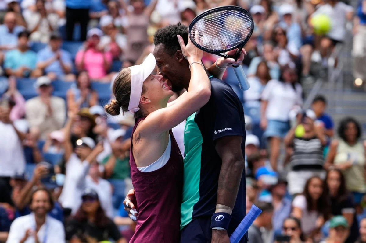 Elina Svitolina, of Ukraine, left, and Gael Monfils, of France, kiss after winning a mixed doubles match at the U.S. Open tennis championships, Tuesday, Aug. 25, 2026, in New York. (AP Photo/Yuki Iwamura)