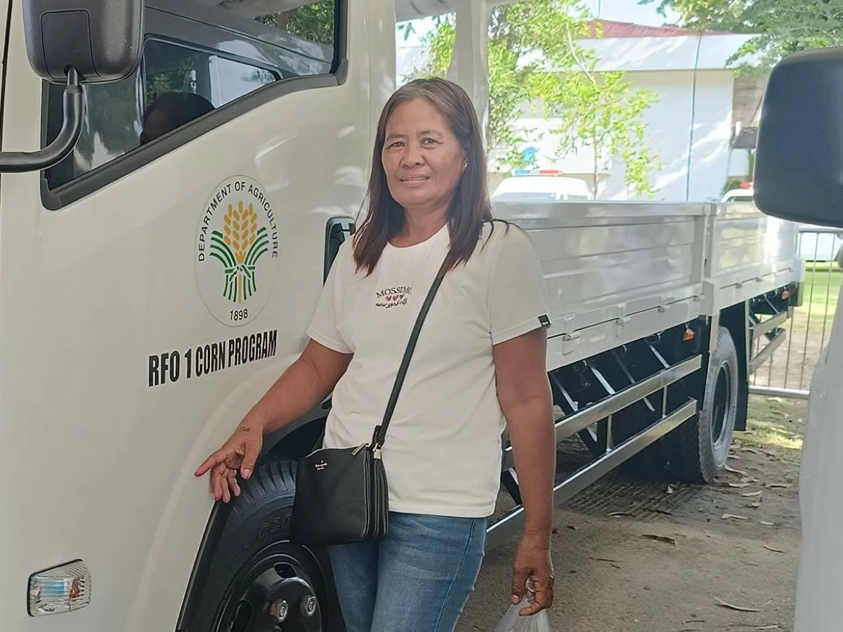 Mendoza poses with a hauling truck, wishing she could one day take one home. It was the day President Ferdinand Marcos Jr. visited the province and vowed to strengthen the agriculture sector—something farmers “barely” feel improving.