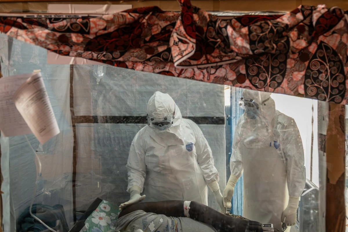 FILE - Health workers tend to an Ebola patient at the Rwampara Treatment Center in Ituri, Congo, Thursday, June 18, 2026. (AP Photo/Moses Sawasawa, file)