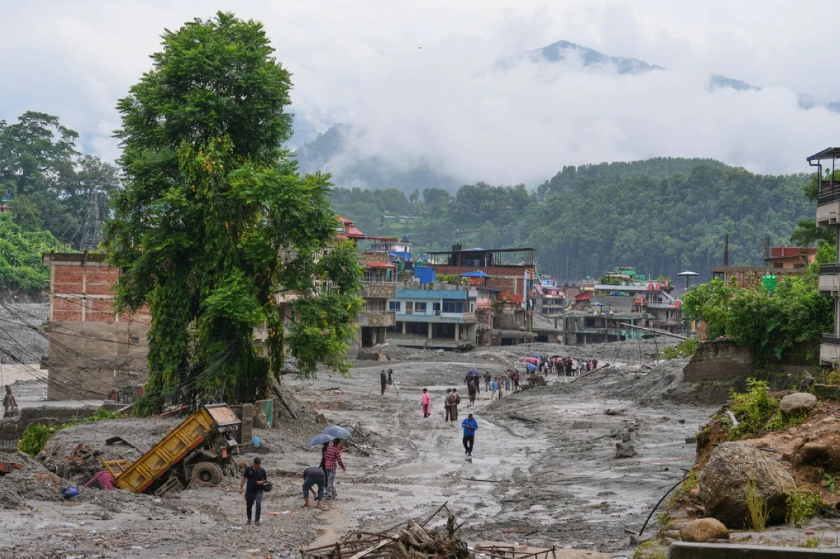 Residents return to their houses to assess the damage following flash flooding in Nuwakot district in Nepal, Saturday, Aug. 29, 2026. (AP Photo/Rajesh Kumar Singh)