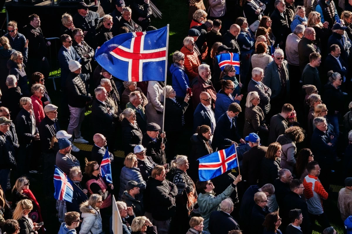 People with Icelandic flags attend an 