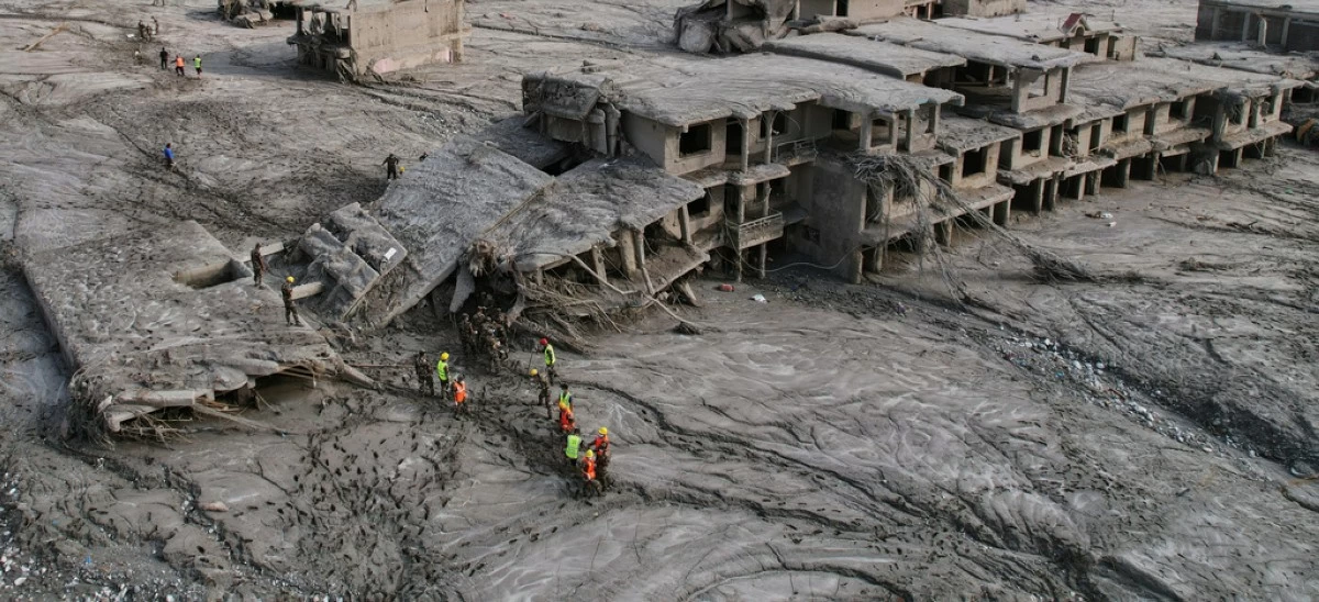 A drone view shows rescue workers inspect the area and damaged structures following recent flash flooding along the Trishuli River in the Devighat area of Nuwakot district, Nepal, Saturday, Aug. 29, 2026. (AP Photo/Rajesh Kumar Singh)