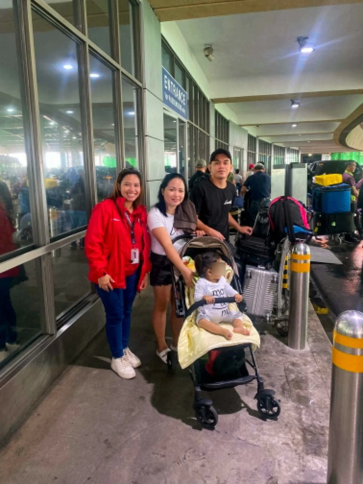 Baby Ayla with her parents and a CSWDO official at the airport departure area before their flight to India. (Photo from Valenzuela LGU)