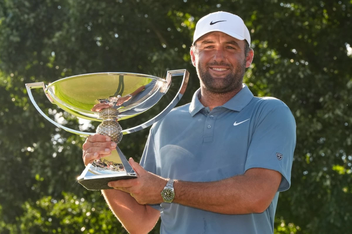 Scottie Scheffler holds the trophy after winning the PGA Tour Championship golf tournament Sunday, Aug. 30, 2026, in Atlanta. (AP Photo/Mike Stewart)