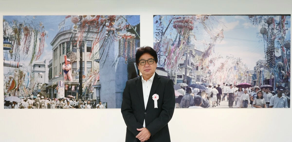 Fujio Chiba stands in front of panels of collected color photographs in Sendai, Miyagi Prefecture, on Aug. 5.