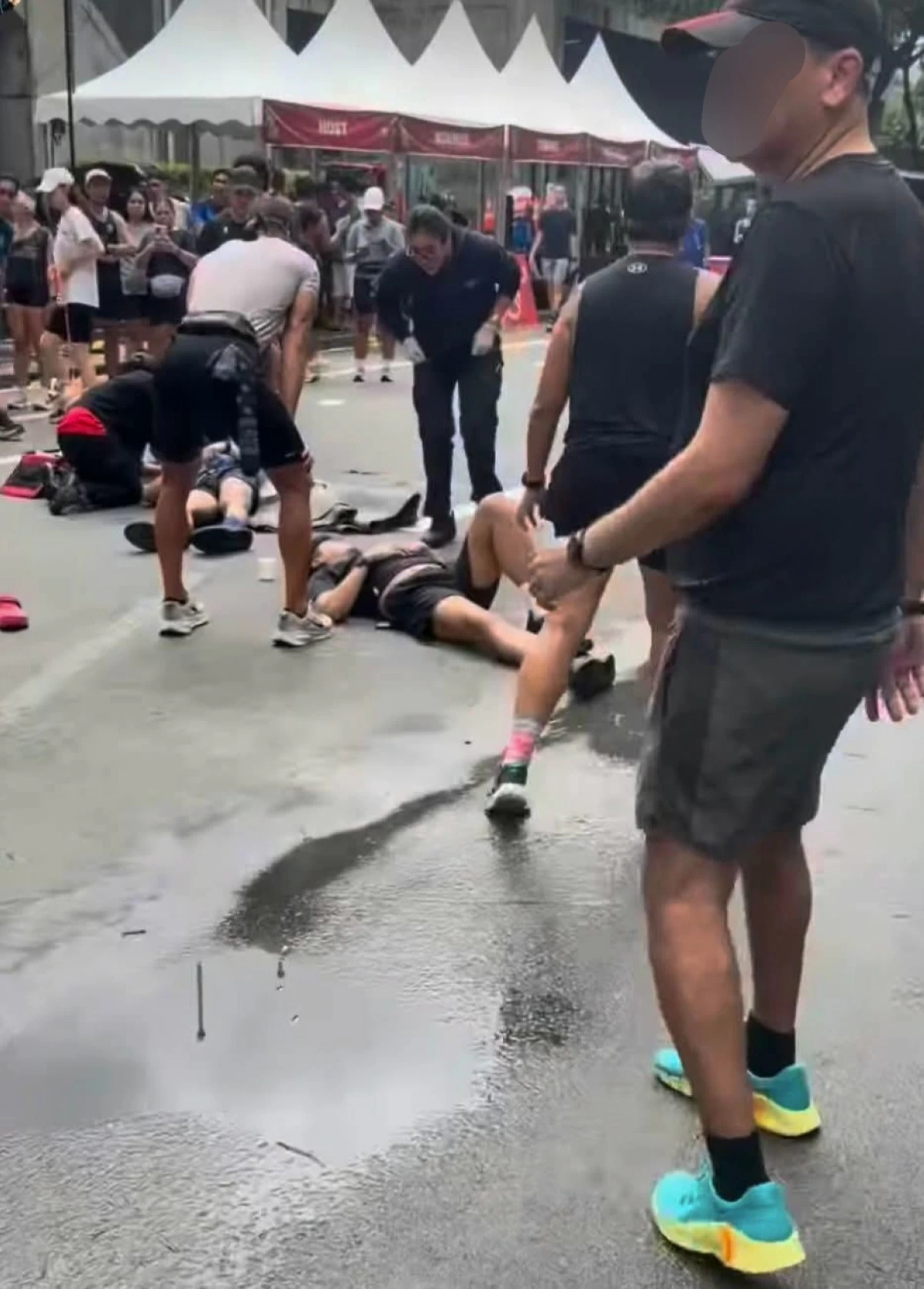 Two runners lie on Ayala Avenue after being hit by a motorcycle during Car-Free Sunday in Makati City. (Screengrab from video by Ron Torres)
