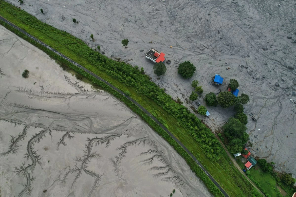 A drone view shows a major section of Pasang Lhamu highway washed away along swollen Trishuli river by recent flash floods cutting off Rasuwa district from Nuwakot area, Nepal, Monday, Aug. 31, 2026. (AP Photo/Rajesh Kumar Singh)