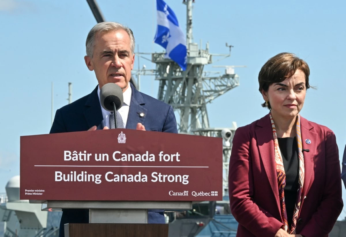 Canadian Prime Minister Mark Carney speaks as he announces a $11.3 billion contract for icebreakers at the Davie shipyard in Levis, Quebec on Monday, Aug. 24, 2026. Quebec Premier Christine Frechette, right, looks on. (Jacques Boissinot/The Canadian Press via AP)