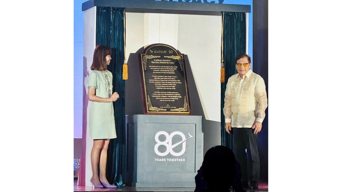 Cathay Pacific’s Lavinia Lau and The Manila Hotel’s Jose D. Lina with the historical marker unveiled during the event. (Photo: Rey Ilagan/Manila Bulletin)