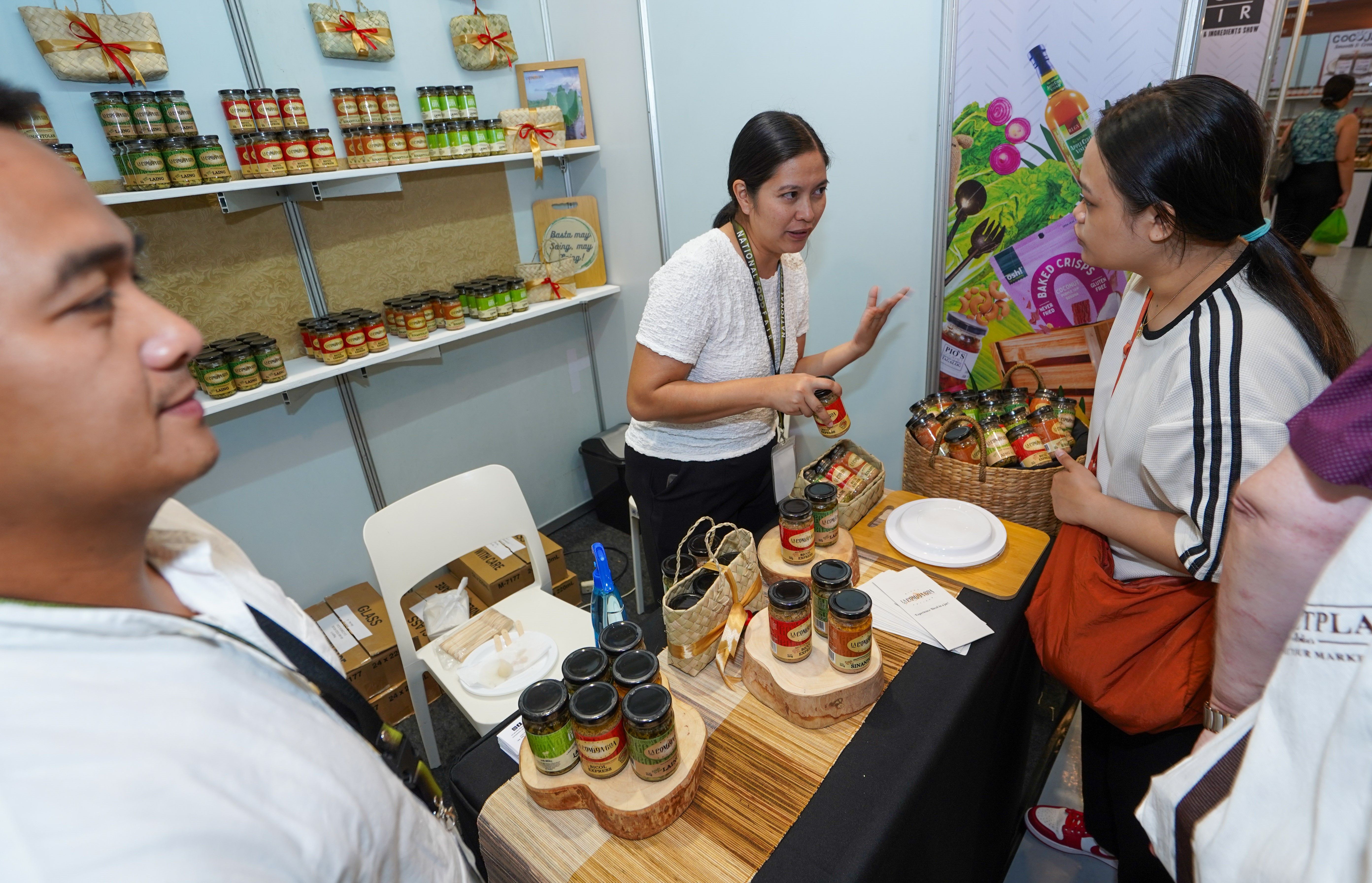 5 COVER PHOTO OPTION 2 - A customer selects bottled Bicol delicacies at the 10th National Food Fair held in SM Megamall’s Megatrade Hall last July..JPG