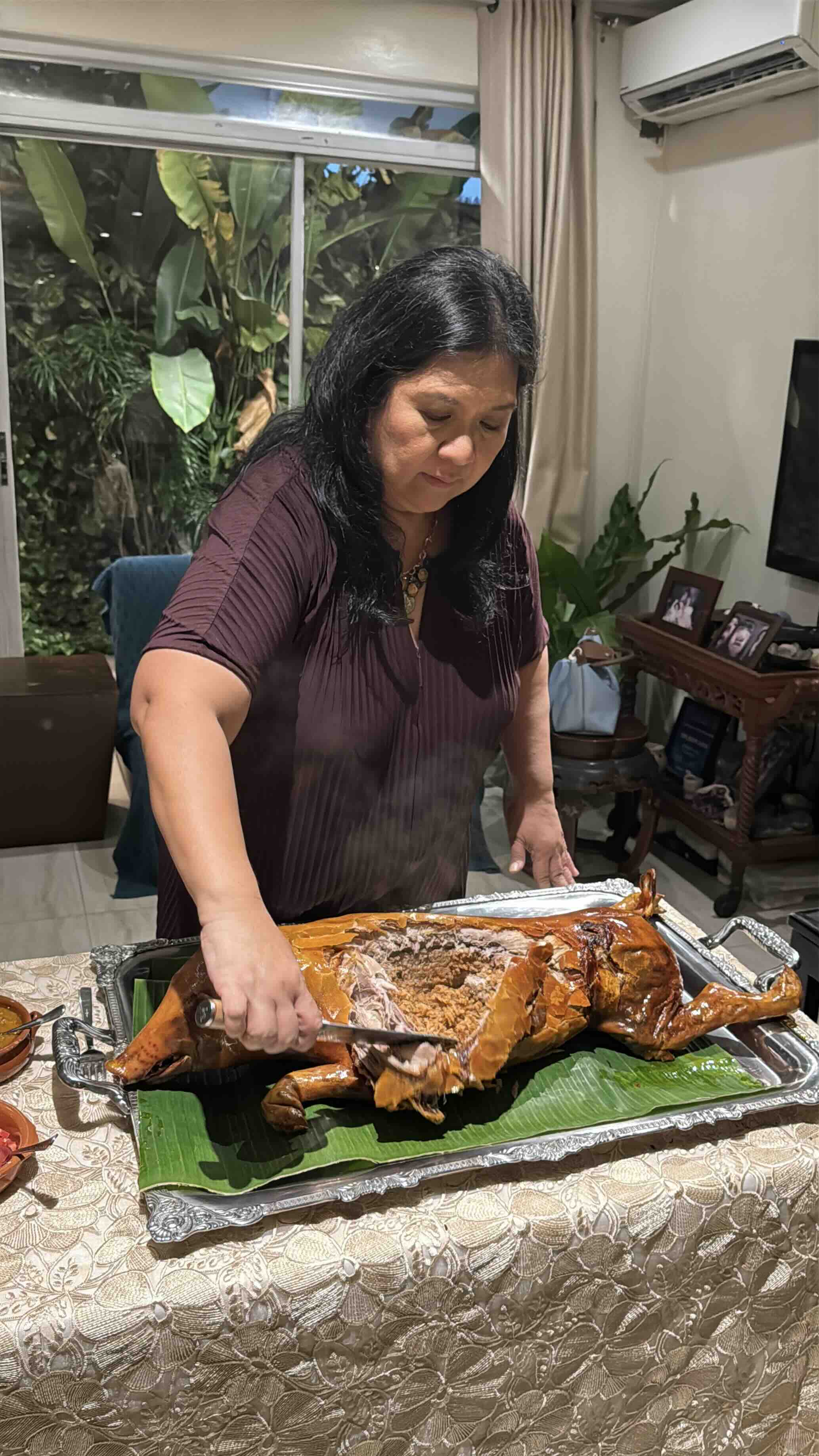BEST RINGTONE Dedet holds a knife over a perfectly browned, fragrant lechon, the crisp crackling ringing through the room with every cut.jpeg