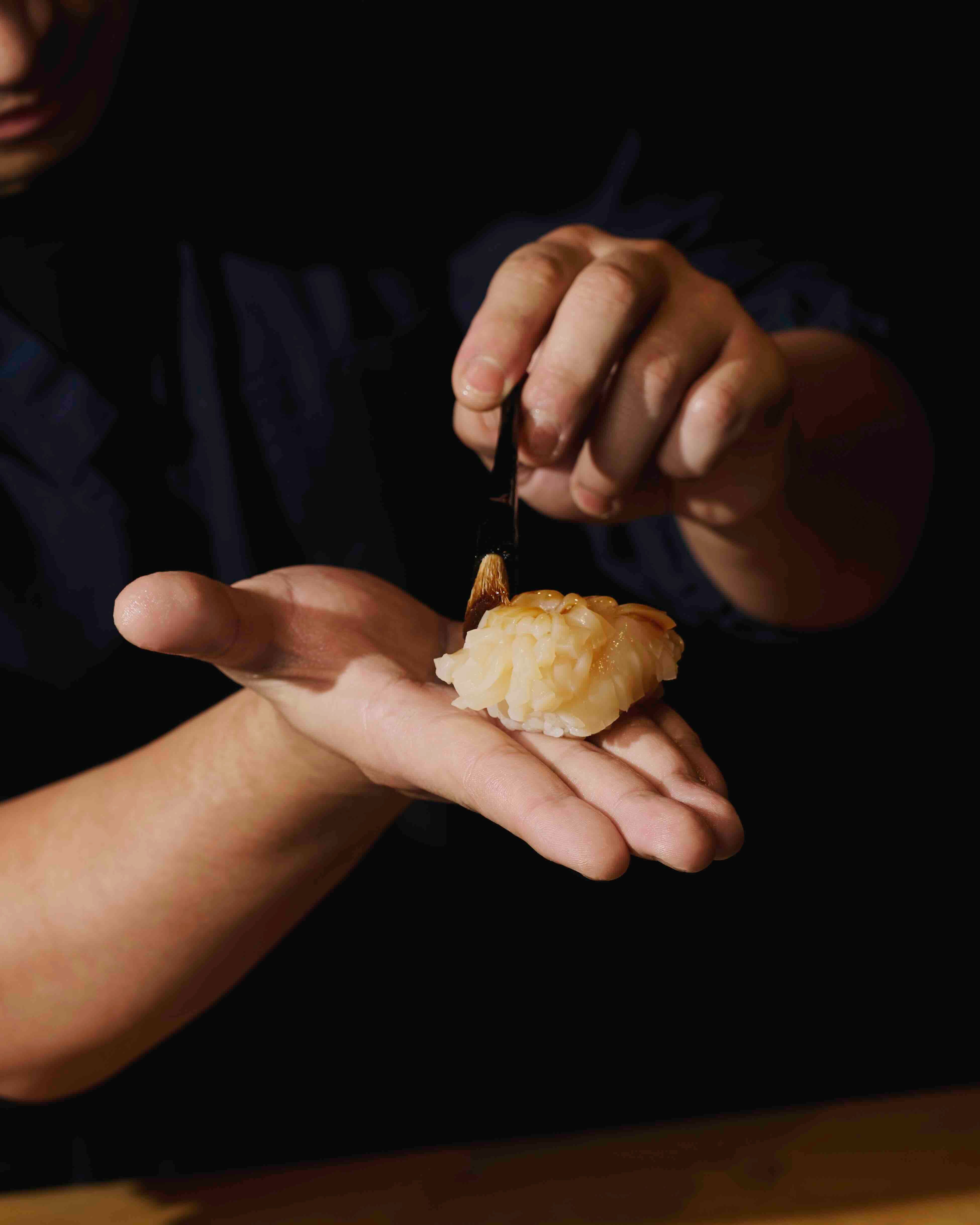 DEFT OF HANDS Scallop nigiri in the making.jpeg