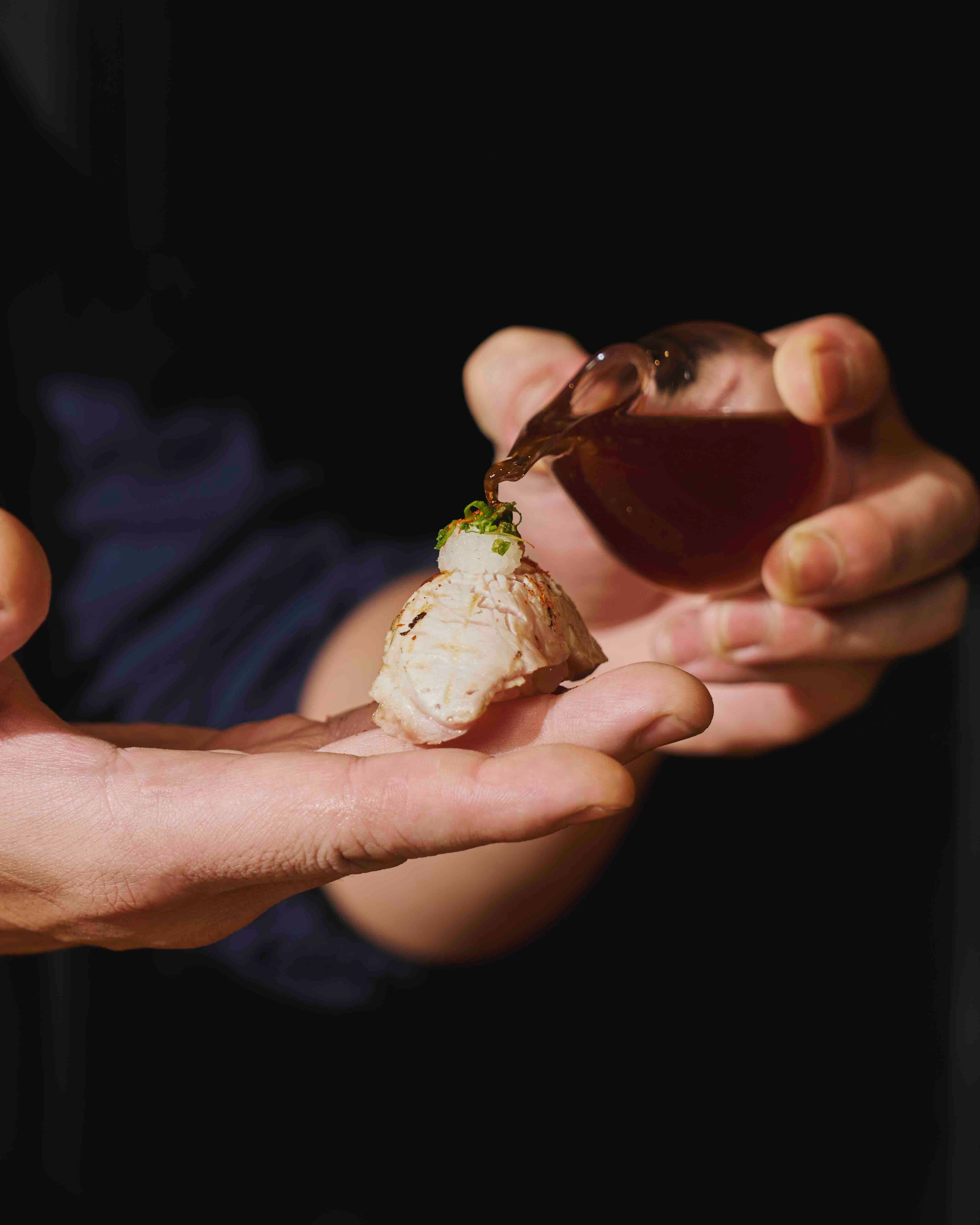 DELICATE LUXURY Flavoring a buri nigiri.jpeg