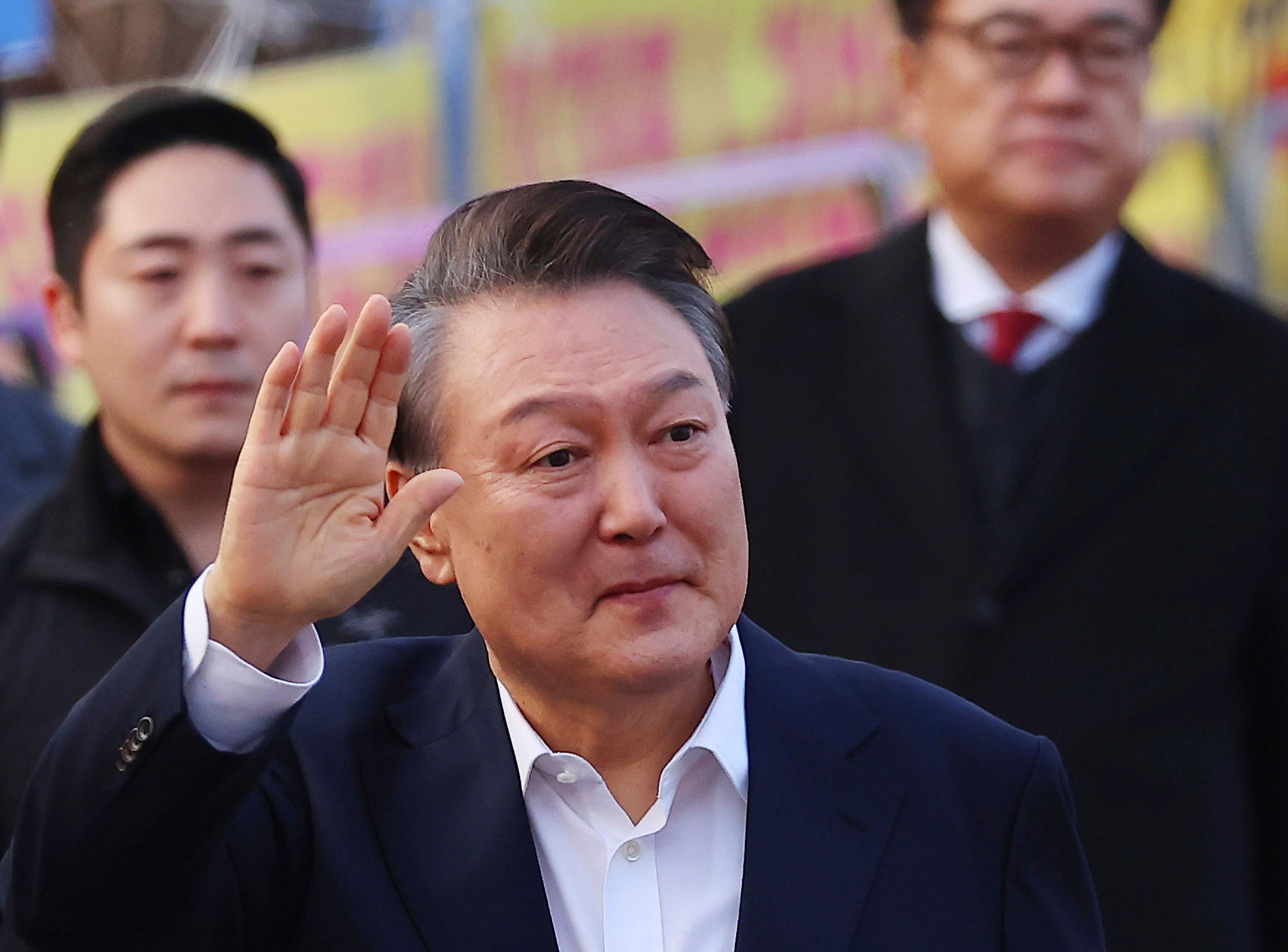 Impeached South Korean President Yoon Suk Yeol greets his supporters as he comes out of a detention center in Uiwang, South Korea, Saturday, March 8, 2025