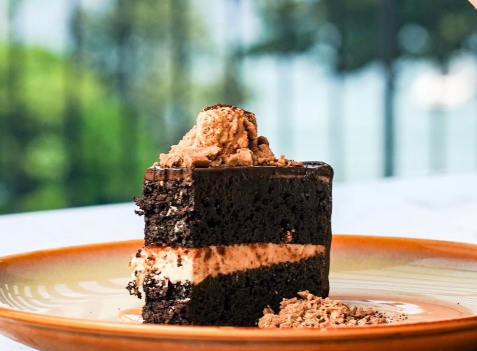 TABLEA CHOCNUT CAKE A decadent moist chocolate cake topped with chocolate-peanut cream and whipped chocolate ganache.jpg