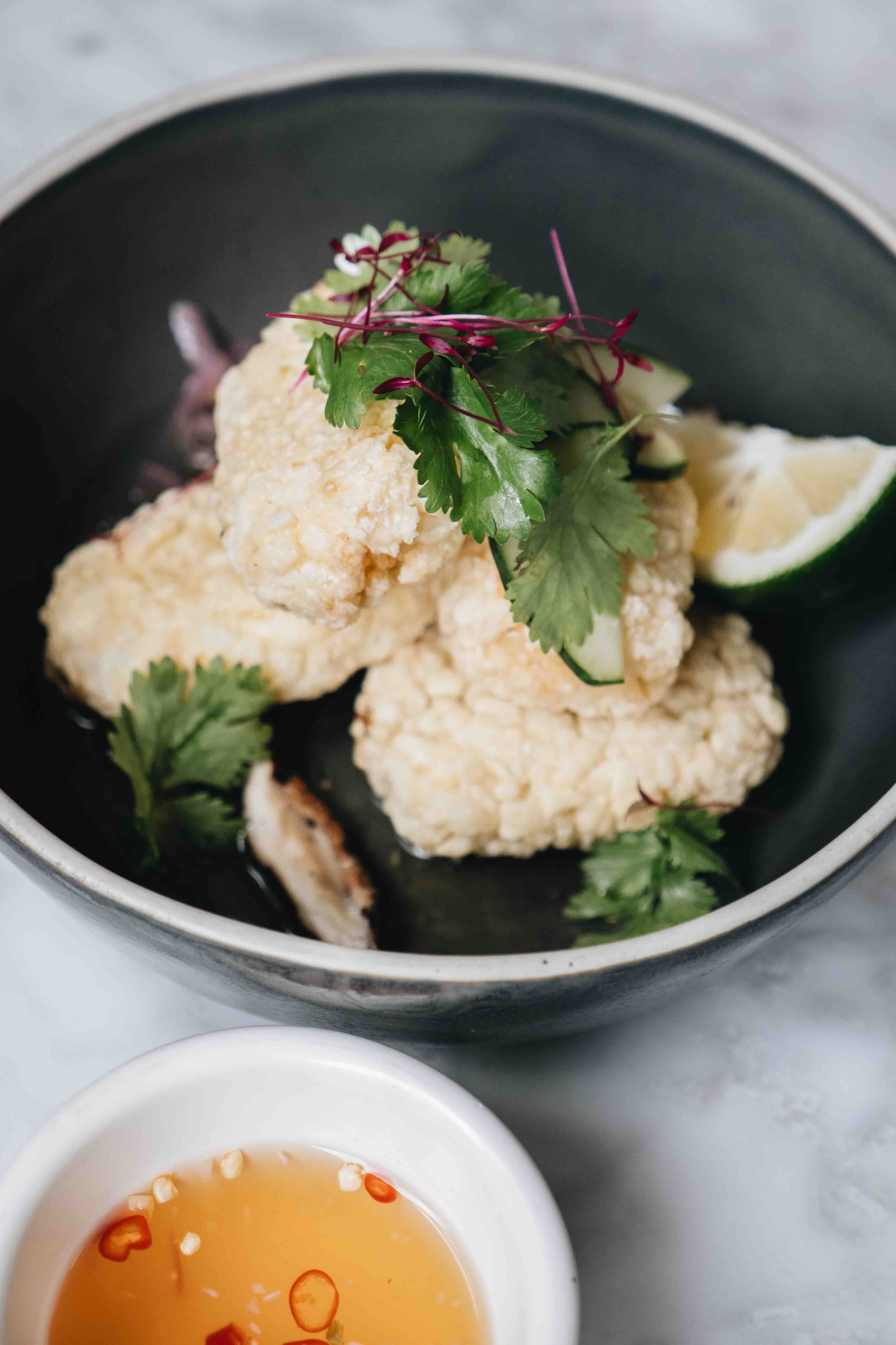 THAI CRISPY RICE Arborio rice, pan-toasted to a crunch, mixed with cilantro, grilled shiitake mushrooms, cucumber, and pickled onion.jpeg