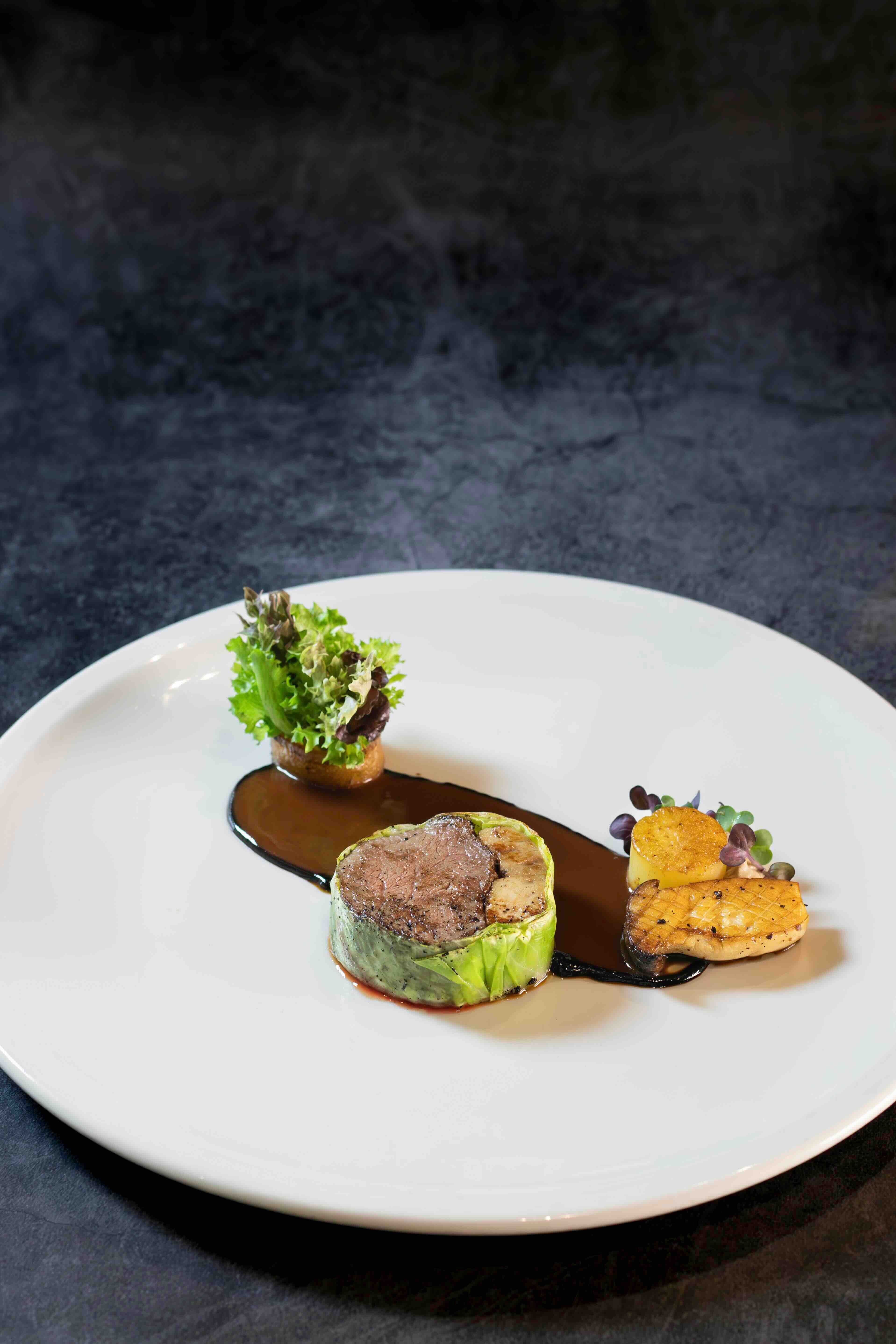US BEEF TENDERLOIN Served with foie gras, napa cabbage, potato fondant, cepe purée, black garlic, mushrooms, and beef jus.jpeg