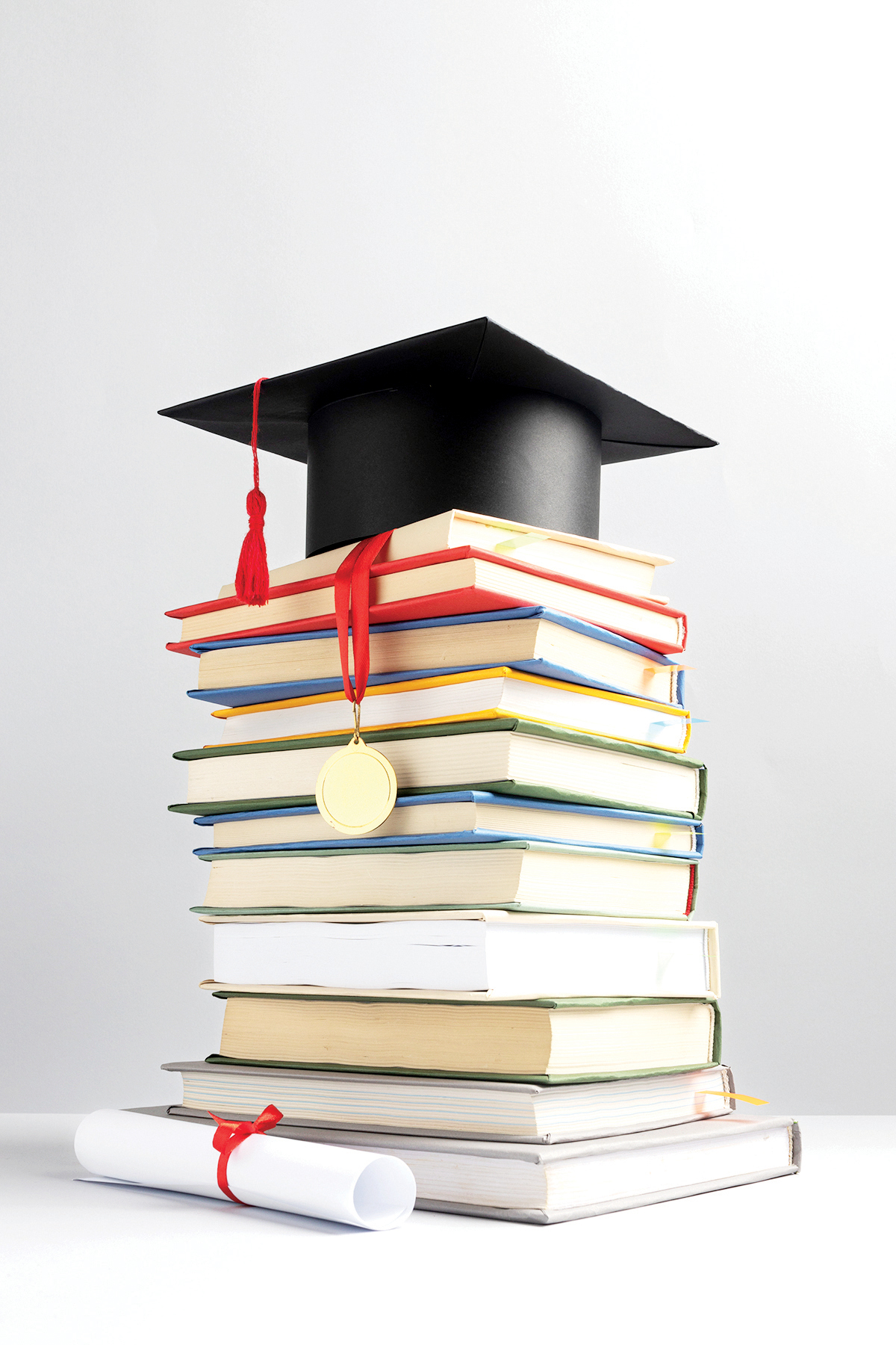 front-view-stacked-books-graduation-cap-diploma-education-day.jpg